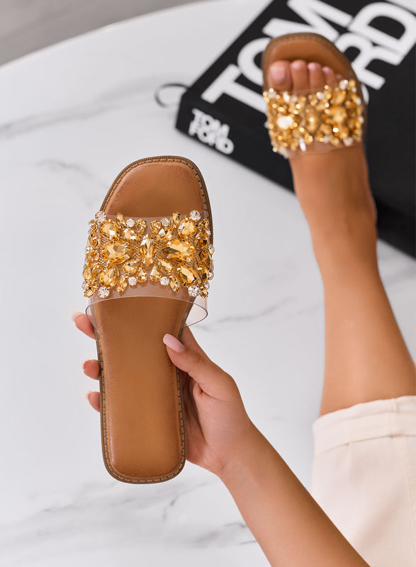 DAFFY - Transparent slide sandals with golden jewel embellishments