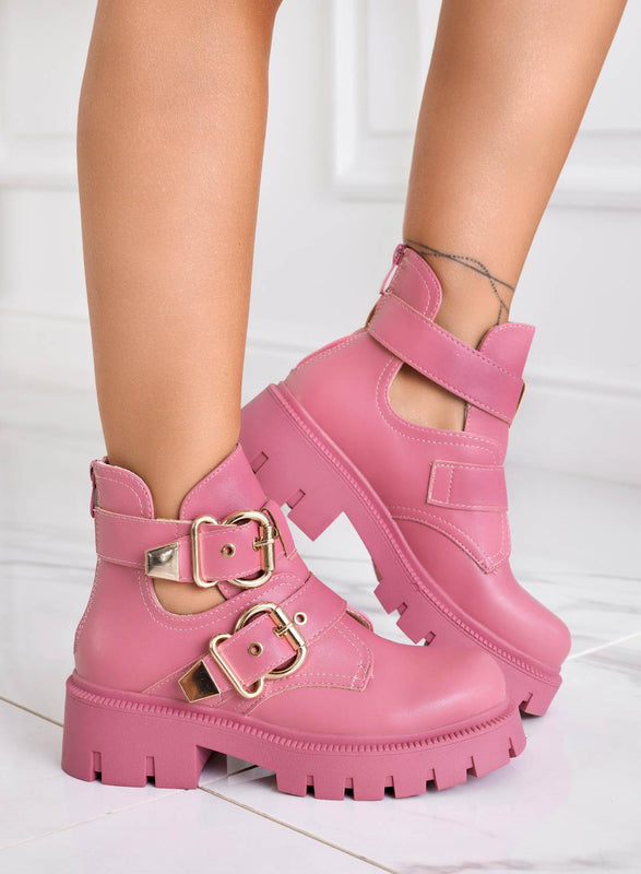 FILE - Open pink amphibian ankle boots with gold buckles