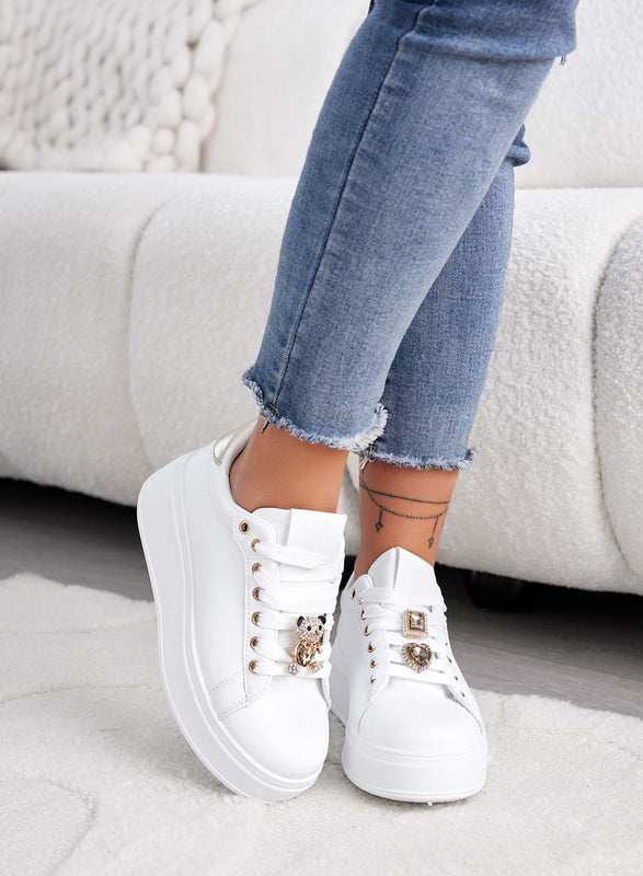 White sneakers with jewel applications and gold teddy
