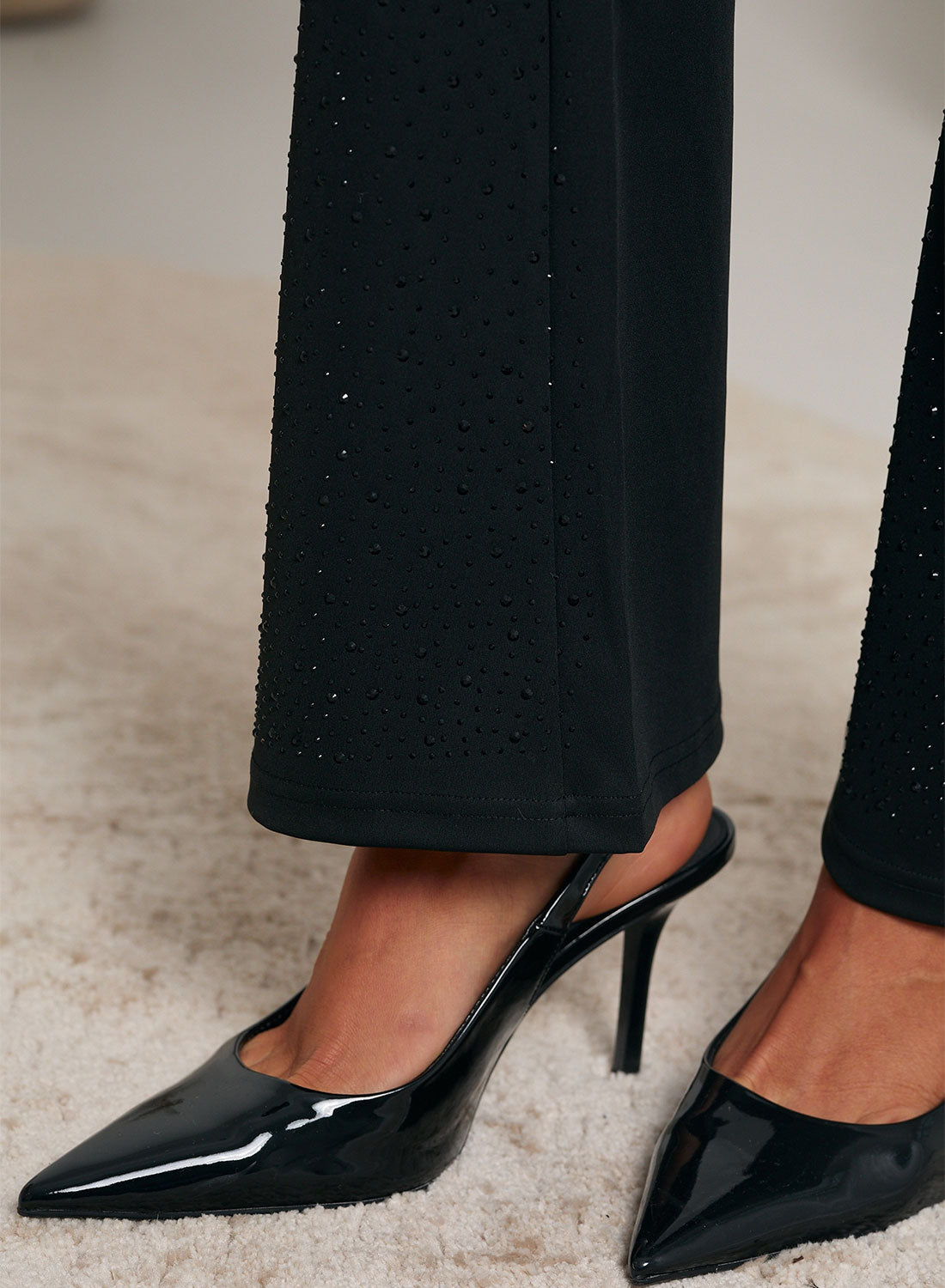 Black bootcut pants decorated with rhinestones