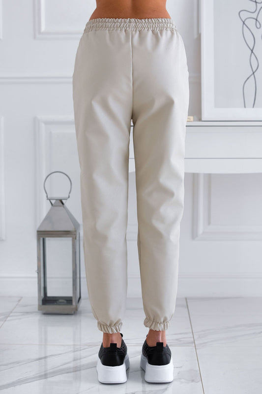 Beige trousers in faux leather with spring and lace at the waist