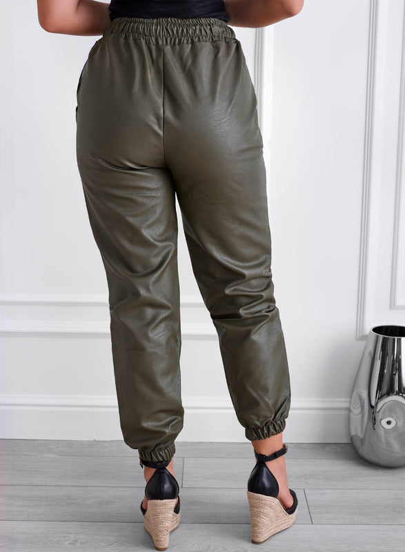 Green faux leather trousers with spring and drawstring at the waist