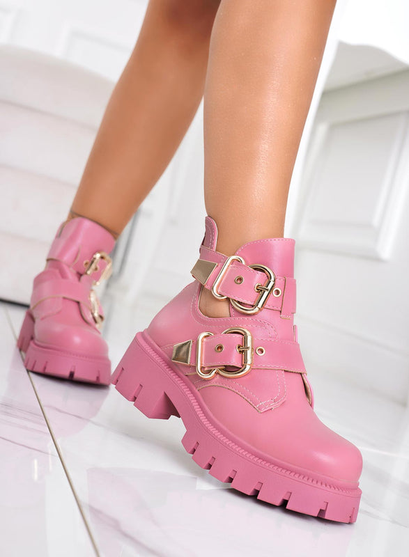 FILE - Open pink amphibian ankle boots with gold buckles