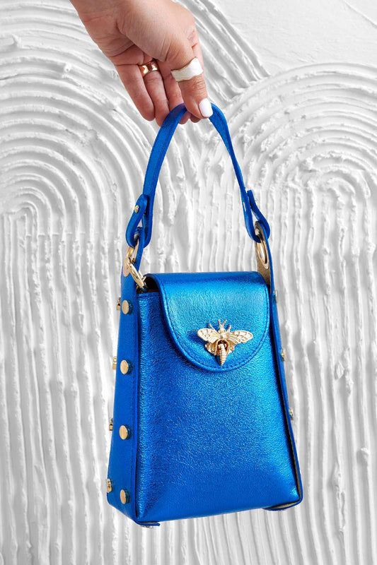 Metallic blue handbag with studs and removable shoulder strap