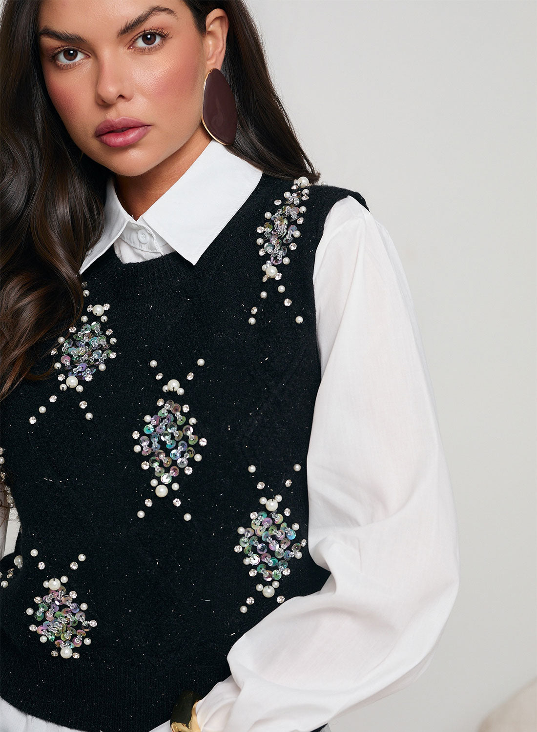 White shirt with black vest decorated with sequins and beads