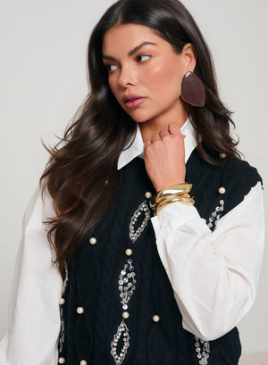 White shirt with black vest decorated with sequins and beads