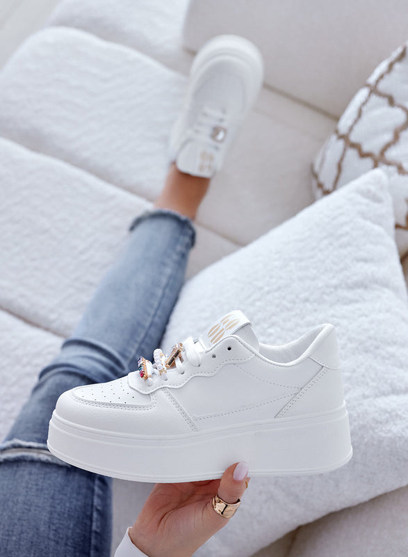White sneakers with jewel embellishments