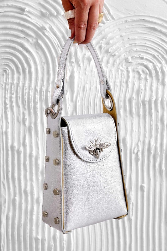 Metallic silver handbag with studs and removable shoulder strap