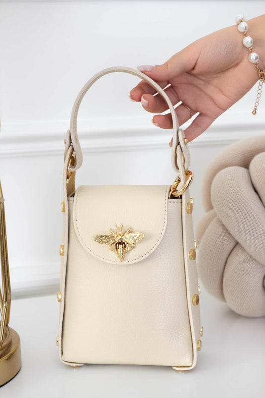 Beige handbag with gold studs and removable shoulder strap