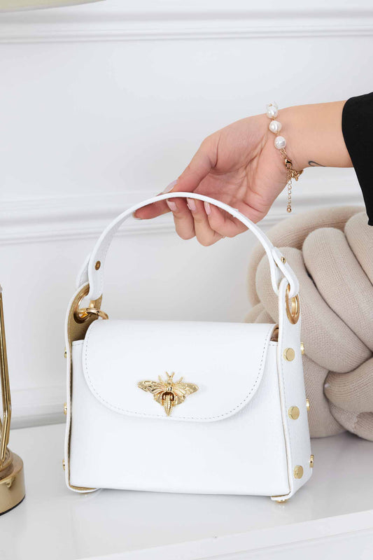 White handbag with gold studs and removable shoulder strap