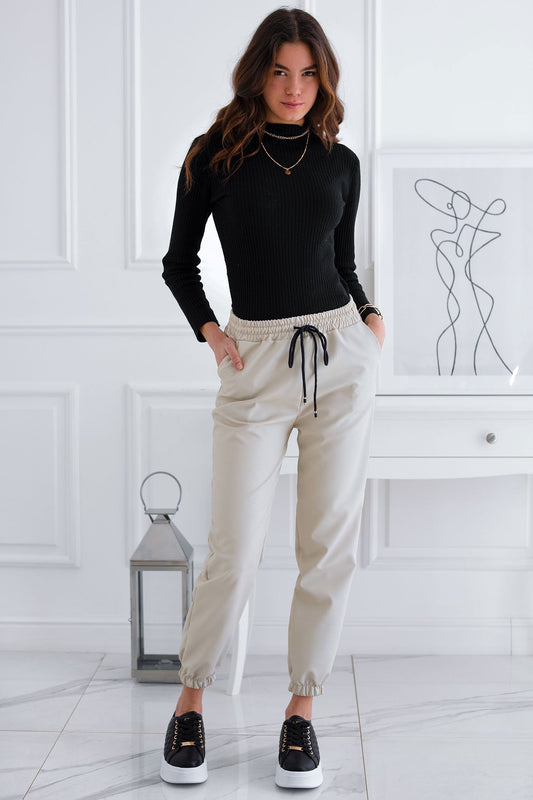 Beige trousers in faux leather with spring and lace at the waist