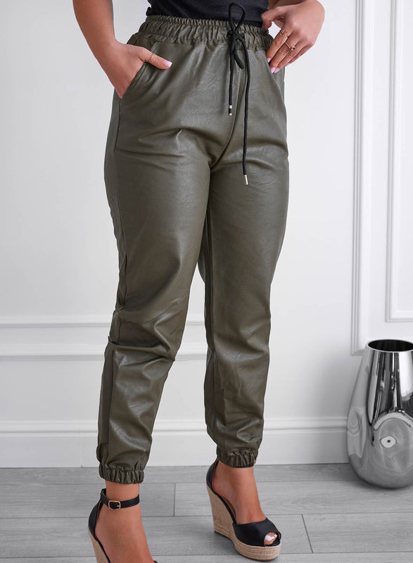 Green faux leather trousers with spring and drawstring at the waist