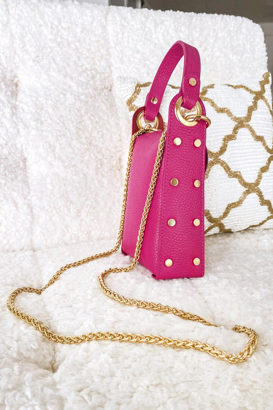 Fuchsia handbag with gold studs and removable shoulder strap