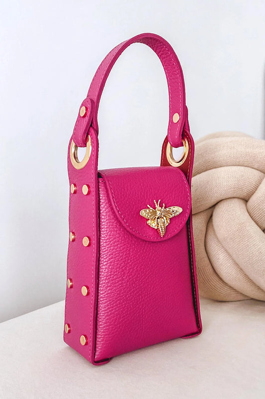 Fuchsia handbag with gold studs and removable shoulder strap