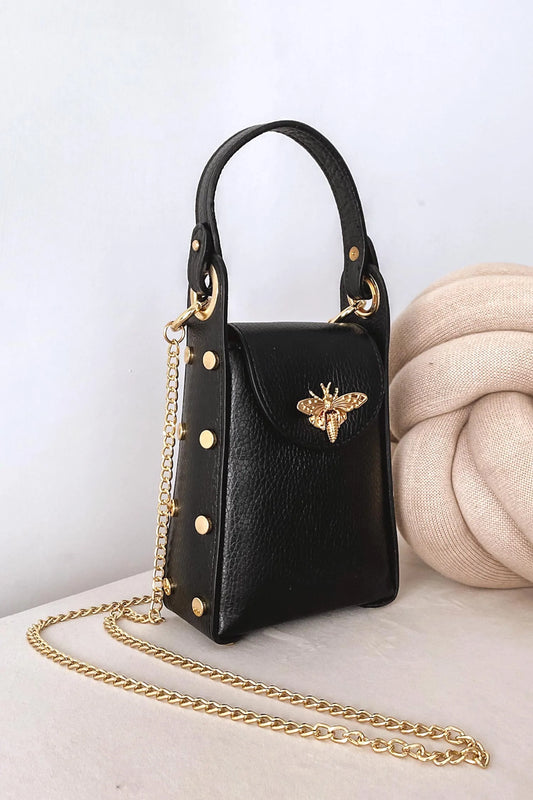 Black handbag with gold studs and removable shoulder strap